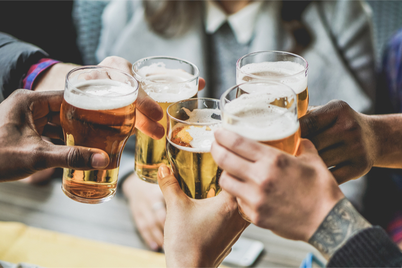 People holding pints of beer