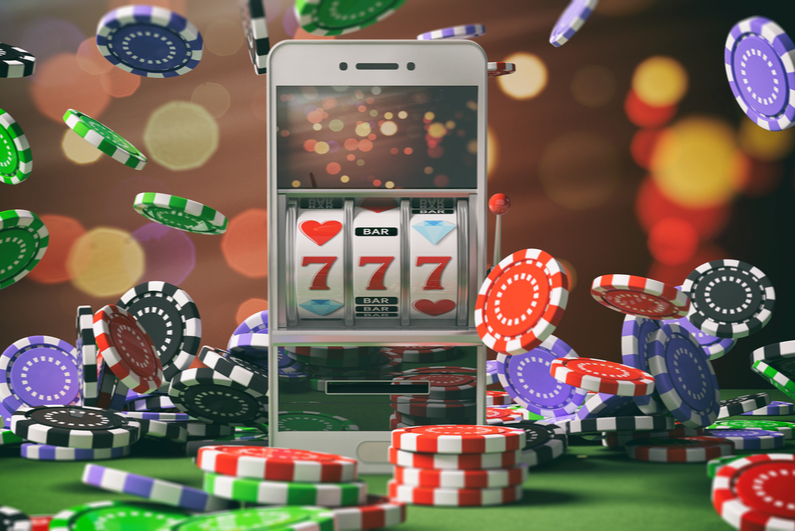 Slot machine on a smartphone screen, poker chips and abstract background