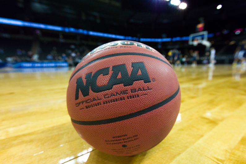 NCAA basketball sitting on a court.