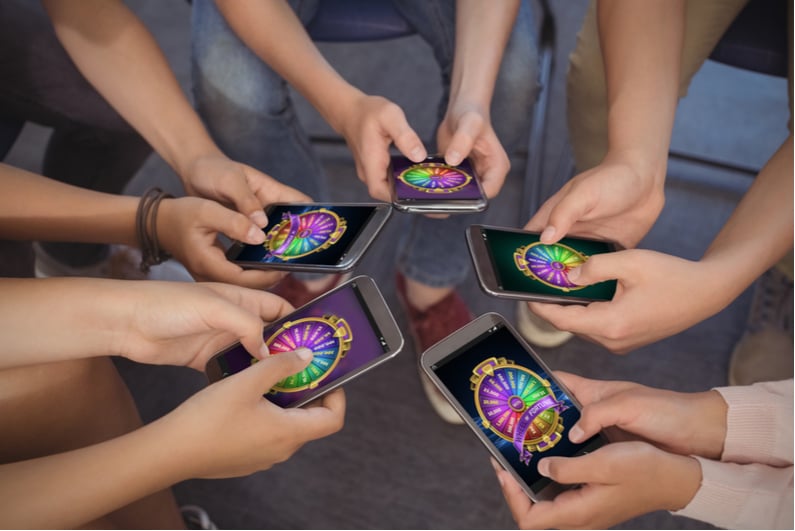 Students viewing wheel of fortune on mobile phones