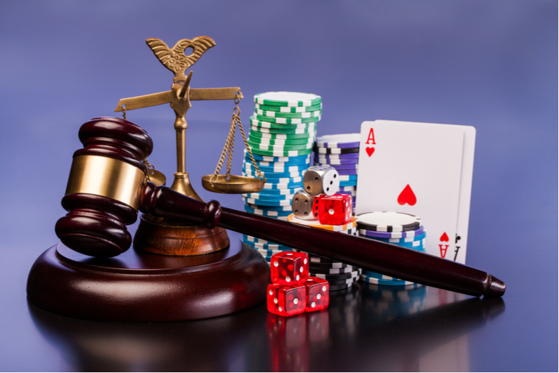 Judge's gavel with dice and cards