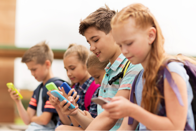 Children looking at their phones