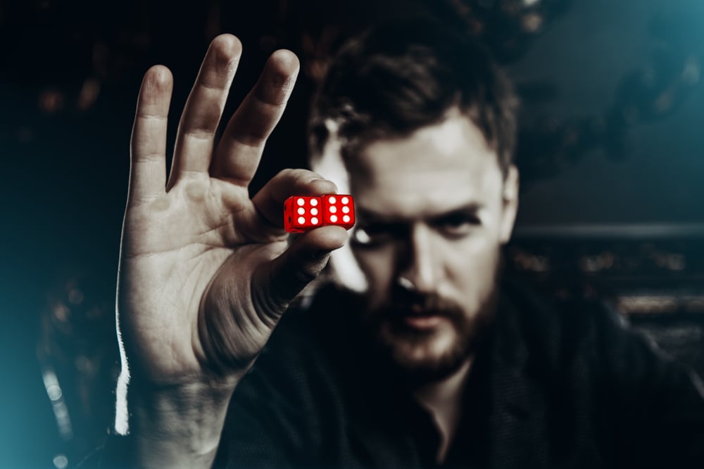 man-holding-a-pair-of-dice