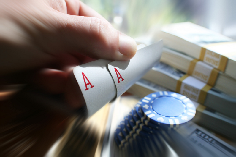 poker player holding pocket aces