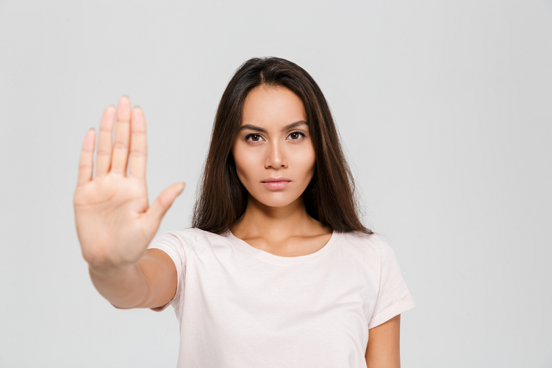 female making stop gesture