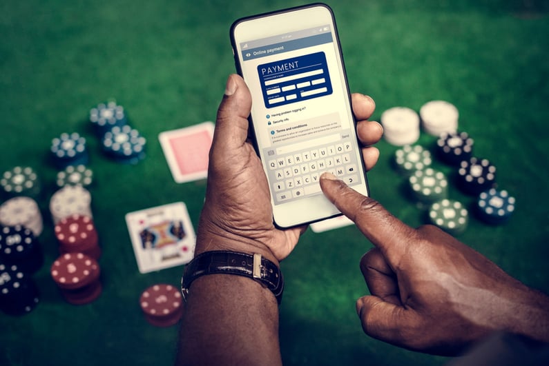 Person paying for gambling on smartphone