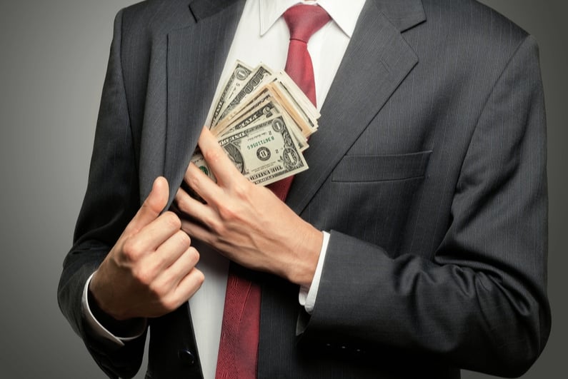 businessman pocketing cash