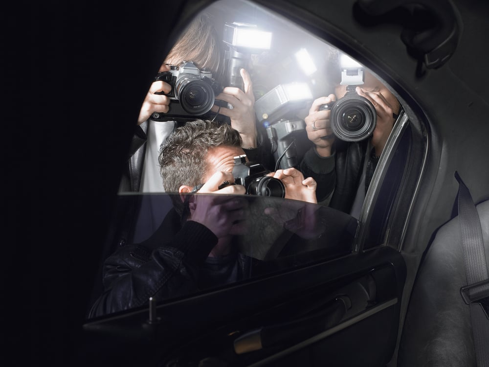 paparazzistanding outside car window take celebrity shots with their cameras