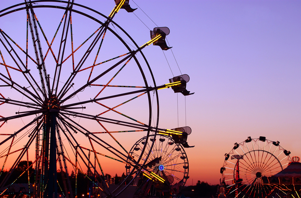 ferriswheel silhouetters against a dusky sky background