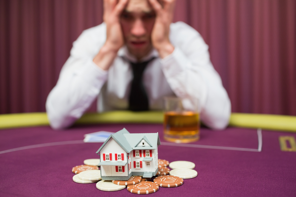 Man appears to be betting his house while playing poker at a casino