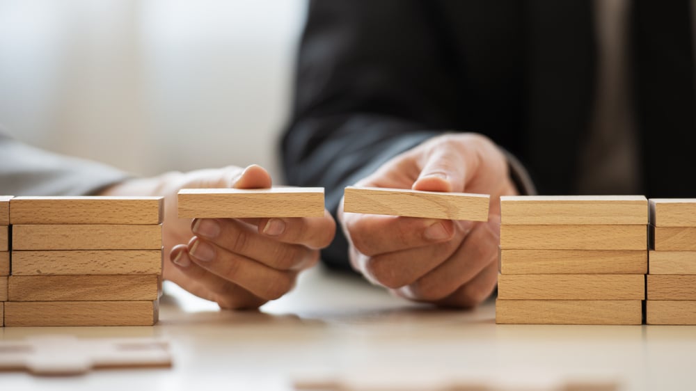 People holding building blocks