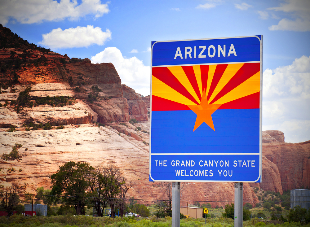 Arizona welcome sign with mountains in the background