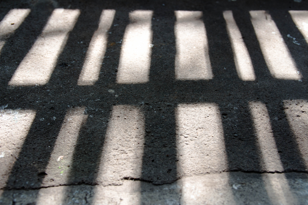 shadow of prison bars on ground