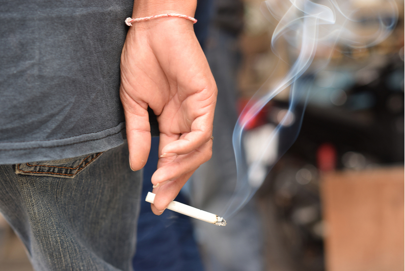 Hand holding a cigarette