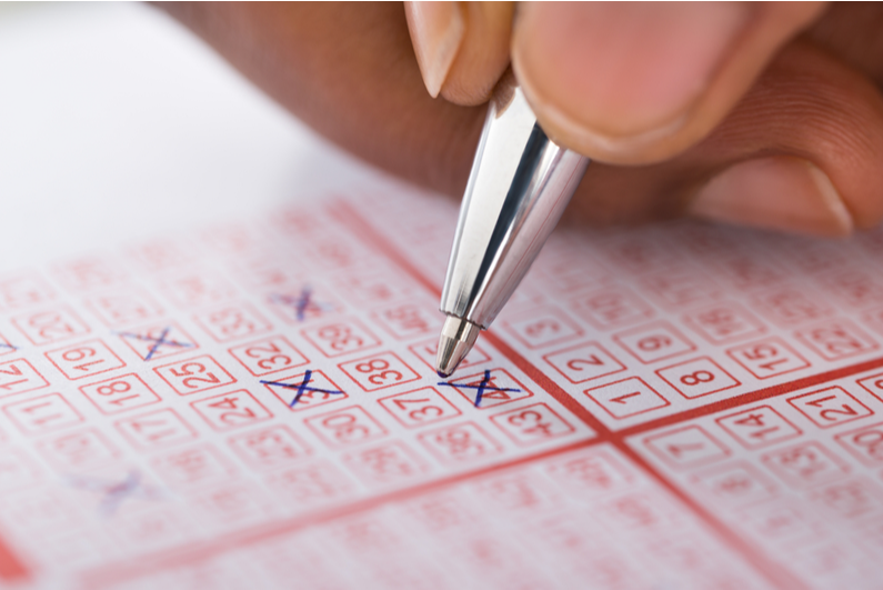 Person filling out lottery ticket